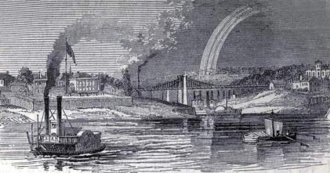 river view, steamboats in foreground, bridge in background