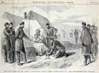 Union troops help free an enslaved woman from shackles
